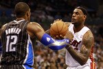 ORLANDO, FL - FEBRUARY 03:  Forward LeBron James #6 (R) of the Miami Heat drives against center Dwight Howard #12 of the Orlando Magic at Amway Arena on February 3, 2011 in Orlando, Florida. NOTE TO USER: User expressly acknowledges and agrees that, by downloading and or using this photograph, User is consenting to the terms and conditions of the Getty Images License Agreement. (Photo by Marc Serota/Getty Images)