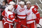 GLENDALE, AZ - APRIL 16:  (L-R) Niklas Kronwall #55, Jonathan Ericsson #52, Justin Abdelkader #8 and Drew Miller #20 of the Detroit Red Wings celebrate after Justin Abdelkader scored a third period goal against the Phoenix Coyotes in Game Two of the Western Conference Quarterfinals during the 2010 NHL Stanley Cup Playoffs at Jobing.com Arena on April 16, 2010 in Glendale, Arizona.  The Red Wings defeated the Coyotes 7-4 to tie the series at 1-1.  (Photo by Christian Petersen/Getty Images)