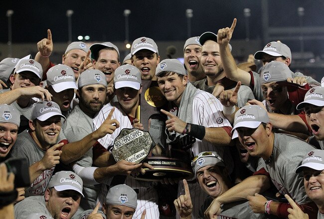 OMAHA, NE - JUNE 28:  (L-R) Brady Thomas #36 and Scott Wingo #8 of the South Carolina Gamecocks celebrate with the team while holding the trophy after winning the men's 2011 NCAA College Baseball World Series at TD Ameritrade Park Omaha on June 28, 2011 in Omaha, Nebraska.  The Gamecocks defeated the Florida Gators 5-2 and won the series 2-0.  (Photo by Ronald Martinez/Getty Images)