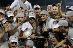 OMAHA, NE - JUNE 28:  (L-R) Brady Thomas #36 and Scott Wingo #8 of the South Carolina Gamecocks celebrate with the team while holding the trophy after winning the men's 2011 NCAA College Baseball World Series at TD Ameritrade Park Omaha on June 28, 2011 in Omaha, Nebraska.  The Gamecocks defeated the Florida Gators 5-2 and won the series 2-0.  (Photo by Ronald Martinez/Getty Images)