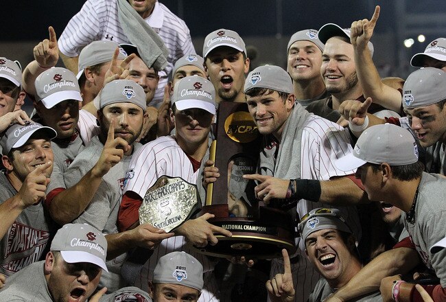OMAHA, NE - JUNE 28:  (L-R) Brady Thomas #36 and Scott Wingo #8 of the South Carolina Gamecocks celebrate with the team while holding the trophy after winning the men's 2011 NCAA College Baseball World Series at TD Ameritrade Park Omaha on June 28, 2011 in Omaha, Nebraska.  The Gamecocks defeated the Florida Gators 5-2 and won the series 2-0.  (Photo by Ronald Martinez/Getty Images)