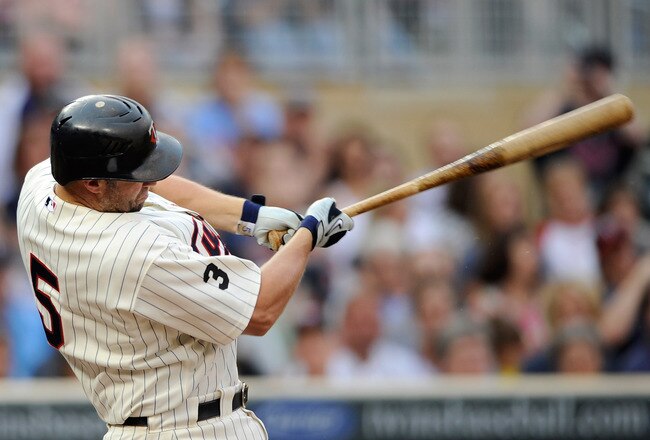 MINNEAPOLIS, MN - JUNE 17: Michael Cuddyer #5 of the Minnesota Twins gets an RBI double against the San Diego Padres in the first inning on June 17, 2011 at Target Field in Minneapolis, Minnesota. (Photo by Hannah Foslien/Getty Images)
