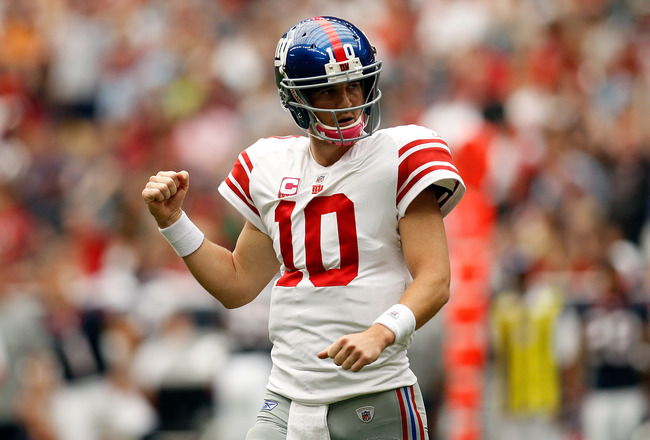 HOUSTON - OCTOBER 10:  Eli Manning #10 of the New York Giants celebrates after throwing a touchdown pass against the Houston Texans at Reliant Stadium on October 10, 2010 in Houston, Texas.  (Photo by Chris Graythen/Getty Images)