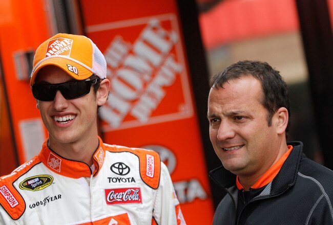 FONTANA, CA - MARCH 25:  Joey Logano, driver of the #20 The Home Depot Toyota, stands in the garage area with crew chief Greg Zipadelli during practice for the NASCAR Sprint Cup Series Auto Club 400 at Auto Club Speedway on March 25, 2011 in Fontana, California.  (Photo by Jason Smith/Getty Images for NASCAR)