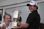 BELFAST, NORTHERN IRELAND - JUNE 22:  US Open winning golfer Rory McIlroy is showered with champagne by club members as he stands with his trophy at Holywood Golf Club on June 22, 2011 in Belfast, Northern Ireland. The 22 year old golfer has returned home to his native Northern Ireland and is giving press interviews and meeting with local supporters.  (Photo by Peter Macdiarmid/Getty Images)