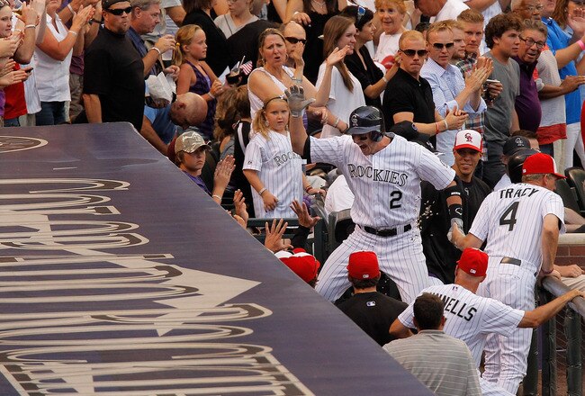DENVER, CO - JULY 1:  Troy Tulowitzki #2 of the Colorado Rockies leaps into the dugout as he celebrates his two-run home run off of starting pitcher Danny Duffy #23 of the Kansas City Royals during the third inning at Coors Field on July 1, 2011 in Denver, Colorado.  (Photo by Justin Edmonds/Getty Images)