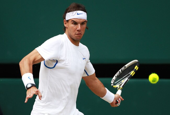 LONDON, ENGLAND - JULY 03:  Rafael Nadal of Spain lines up a shot during his final round Gentlemen's match against Novak Djokovic of Serbia on Day Thirteen of the Wimbledon Lawn Tennis Championships at the All England Lawn Tennis and Croquet Club on July 3, 2011 in London, England.  (Photo by Julian Finney/Getty Images)