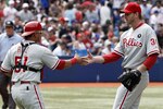 TORONTO, CANADA - JULY 2: Carlos Ruiz #51 and Roy Halladay #34 of the Philadelphia Phillies celebrate win against the Toronto Blue Jays during MLB action at The Rogers Centre July 2, 2011 in Toronto, Ontario, Canada. (Photo by Abelimages/Getty Images)