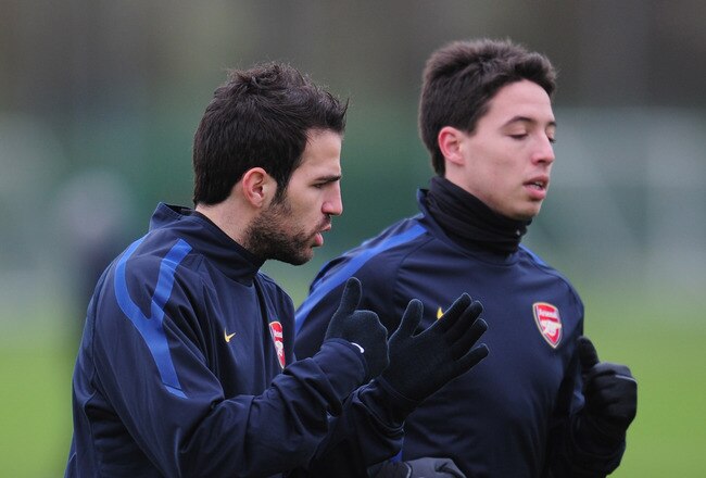 ST ALBANS, ENGLAND - FEBRUARY 15:  Cesc Fabregas and Samir Nasri of Arsenal warm-up during training at London Colney on February 15, 2011 in St Albans, England.  (Photo by Shaun Botterill/Getty Images)