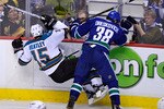 VANCOUVER, CANADA - MAY 24:  Victor Oreskovich #38 of the Vancouver Canucks checks Dany Heatley #15 of the San Jose Sharks in the first period in Game Five of the Western Conference Finals during the 2011 Stanley Cup Playoffs at Rogers Arena on May 24, 2011 in Vancouver, British Columbia, Canada. (Photo by Rich Lam/Getty Images)