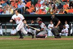 BALTIMORE, MD - JUNE 29:  Mark Reynolds #12 of the Baltimore Orioles follows his hit as catcher Yadier Molina #4 of the St. Louis Cardinals looks on at Oriole Park at Camden Yards on June 29, 2011 in Baltimore, Maryland.  (Photo by Rob Carr/Getty Images)