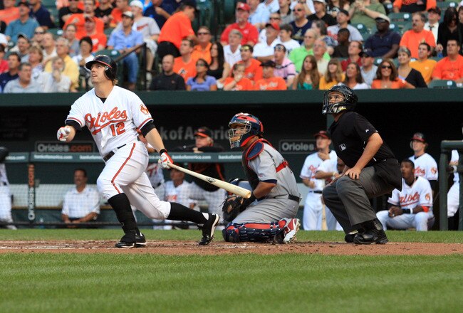 BALTIMORE, MD - JUNE 29:  Mark Reynolds #12 of the Baltimore Orioles follows his hit as catcher Yadier Molina #4 of the St. Louis Cardinals looks on at Oriole Park at Camden Yards on June 29, 2011 in Baltimore, Maryland.  (Photo by Rob Carr/Getty Images)