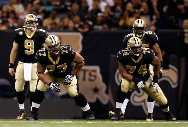 NEW ORLEANS - JANUARY 16:  (L-R) Offensive lineman Carl Nicks #77 and Jermon Bushrod #74 of the New Orleans Saints get set to pass protect as Drew Brees #9 and Reggie Bush #25 await the snap against the Arizona Cardinals during the NFC Divisional Playoff Game at Louisana Superdome on January 16, 2010 in New Orleans, Louisiana. The Saints won 45-14.  (Photo by Chris Graythen/Getty Images)