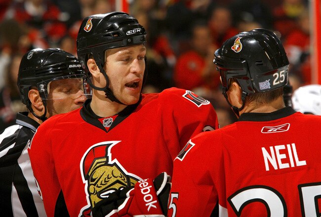 OTTAWA, ON - OCTOBER 08:   Matt Carkner #39 and Chris Neil #25 of the Ottawa Senators discuss strategy before a faceoff against the Buffalo Sabres during a game at Scotiabank Place on October 8, 2010 in Ottawa, Ontario,  Canada. The Buffalo Sabres defeated the Ottawa Senators 2-1.  (Photo by Phillip MacCallum/Getty Images)