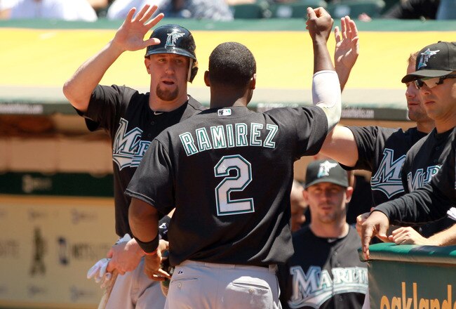 OAKLAND, CA - JUNE 30:  Hanley Ramirez #2 of the Florida Marlins is congratulated by John Buck #14 of the Florida Marlins after he scored in the fifth inning against the Oakland Athletics at Oakland-Alameda County Coliseum on June 30, 2011 in Oakland, California.  (Photo by Ezra Shaw/Getty Images)