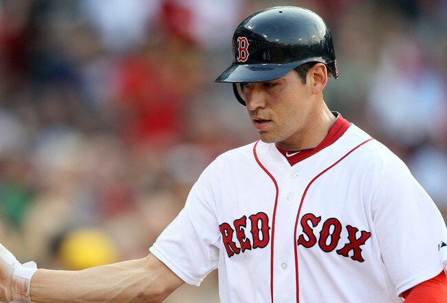 BOSTON, MA - JULY 06:  Jacoby Ellsbury #2 of the Boston Red Sox is congratulated by teammates in the dugout after he hit a solo home run in the first inning against the Toronto Blue Jays on July 6, 2011 at Fenway Park in Boston, Massachusetts.  (Photo by Elsa/Getty Images)