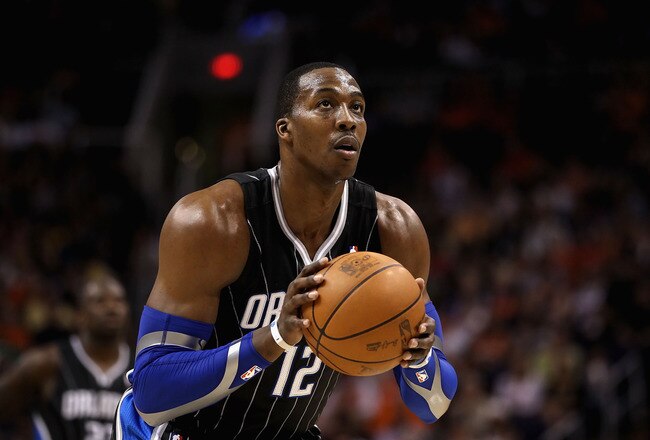 PHOENIX, AZ - MARCH 13:  Dwight Howard #12 of the Orlando Magic shoots a free throw shot during the NBA game against the Phoenix Suns at US Airways Center on March 13, 2011 in Phoenix, Arizona. The Magic defeated the Suns 111-88. NOTE TO USER: User expressly acknowledges and agrees that, by downloading and or using this photograph, User is consenting to the terms and conditions of the Getty Images License Agreement.  (Photo by Christian Petersen/Getty Images)