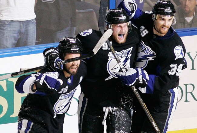 TAMPA, FL - MAY 25:  Martin St. Louis #26 celebrates his third period goal with Steven Stamkos #91 and Mike Lundin #39 of the Tampa Bay Lightning in Game Six of the Eastern Conference Finals against the Boston Bruins during the 2011 NHL Stanley Cup Playoffs at St Pete Times Forum on May 25, 2011 in Tampa, Florida.  (Photo by Justin K. Aller/Getty Images)