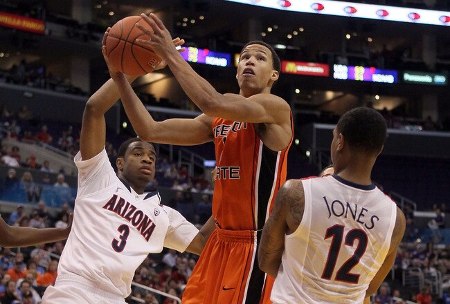 LOS ANGELES, CA - MARCH 10:  Jared Cunningham #1 of the Oregon State Beavers goes up for a shot between Kevin Parrom #3 and Lamont Jones #12 of the Arizona Wildcats in the first half in the quarterfinals of the 2011 Pacific Life Pac-10 Men's Basketball Tournament at Staples Center on March 10, 2011 in Los Angeles, California.  (Photo by Stephen Dunn/Getty Images)