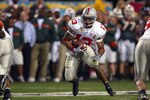 TEMPE, AZ - JANUARY 3:  Running back Maurice Clarett #13 of the Ohio State Buckeyes finds a hole against the University of Miami Hurricanes during the Tostitos Fiesta Bowl at Sun Devil Stadium on January 3, 2003 in Tempe, Arizona.  Ohio State won the game 31-24 in double-overtime, winning the NCAA National Championship.  (Photo by Jamie Squire/Getty Images)