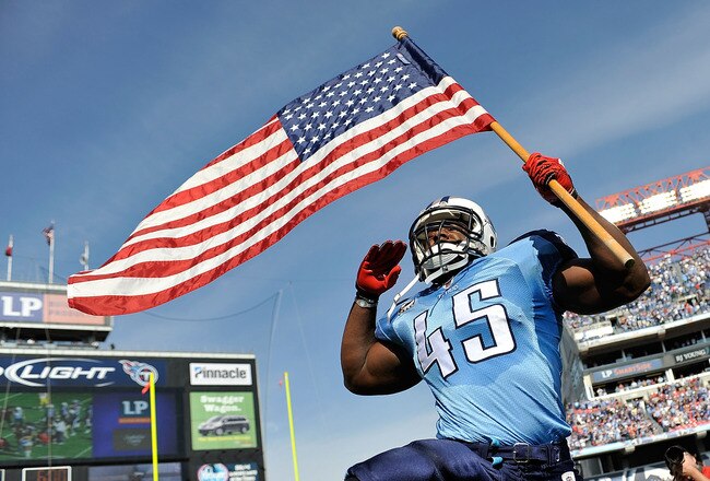 NASHVILLE, TN - NOVEMBER 21:  Ahmard Hall #45 of the Tennessee Titans, an armed services veteran, brings out the American flag before a game against the Washington Redskins at LP Field on November 21, 2010 in Nashville, Tennessee.  (Photo by Grant Halverson/Getty Images)