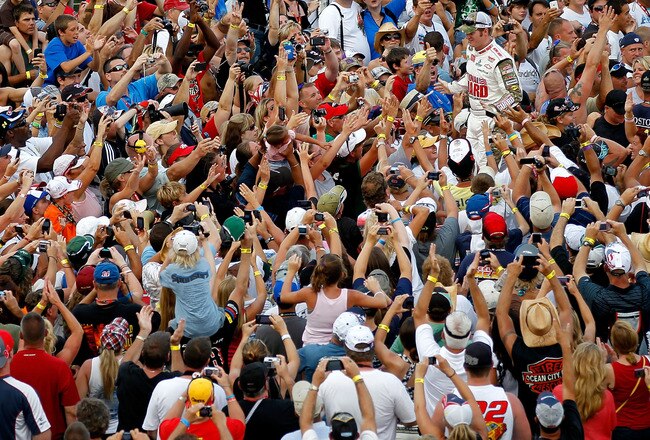 DAYTONA BEACH, FL - JULY 02:  Dale Earnhardt Jr., driver of the #88 National Guard Heritage/Amp Energy Chevrolet, greets fans during driver introductions prior to the running of the NASCAR Sprint Cup Series Coke ZERO 400 Powered by Coca-Cola at Daytona International Speedway on July 2, 2011 in Daytona Beach, Florida.  (Photo by Mike Ehrmann/Getty Images for NASCAR)