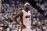 MIAMI, FL - JUNE 12:  LeBron James #6 of the Miami Heat looks on as Dwyane Wade stands in the background against the Dallas Mavericks in Game Six of the 2011 NBA Finals at American Airlines Arena on June 12, 2011 in Miami, Florida. NOTE TO USER: User expressly acknowledges and agrees that, by downloading and/or using this Photograph, user is consenting to the terms and conditions of the Getty Images License Agreement.  (Photo by Mike Ehrmann/Getty Images)