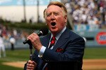 LOS ANGELES - APRIL 13:  Dodgers broadcaster Vin Scully gives the call of 'It's time for Dodger baseball!' during pregame ceremonies for the Los Angeles Dodgers home opener against the San Francisco Giants on April 13, 2009 at Dodger Stadiium in Los Angeles, California. (Photo by Stephen Dunn/Getty Images)