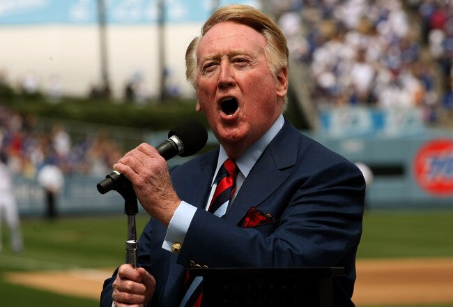 LOS ANGELES - APRIL 13:  Dodgers broadcaster Vin Scully gives the call of 'It's time for Dodger baseball!' during pregame ceremonies for the Los Angeles Dodgers home opener against the San Francisco Giants on April 13, 2009 at Dodger Stadiium in Los Angeles, California. (Photo by Stephen Dunn/Getty Images)