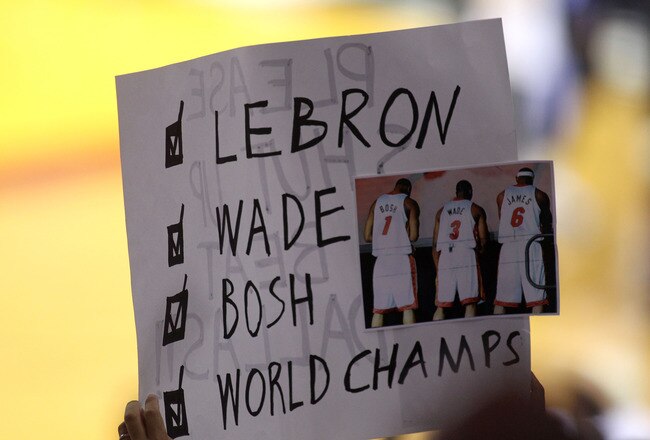 MIAMI, FL - JUNE 12:  Fans of the Miami Heat holds up a sign in support of LeBron James, Dwyane Wade and Chris Bosh in Game Six of the 2011 NBA Finals at American Airlines Arena on June 12, 2011 in Miami, Florida. NOTE TO USER: User expressly acknowledges and agrees that, by downloading and/or using this Photograph, user is consenting to the terms and conditions of the Getty Images License Agreement.  (Photo by Marc Serota/Getty Images)