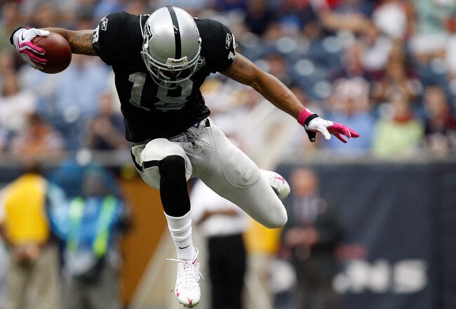 HOUSTON - OCTOBER 04:  Wide receiver Louis Murphy #18 of the Oakland Raiders jumps over a tackle by the Houston Texans at Reliant Stadium on October 4, 2009 in Houston, Texas.  (Photo by Ronald Martinez/Getty Images)