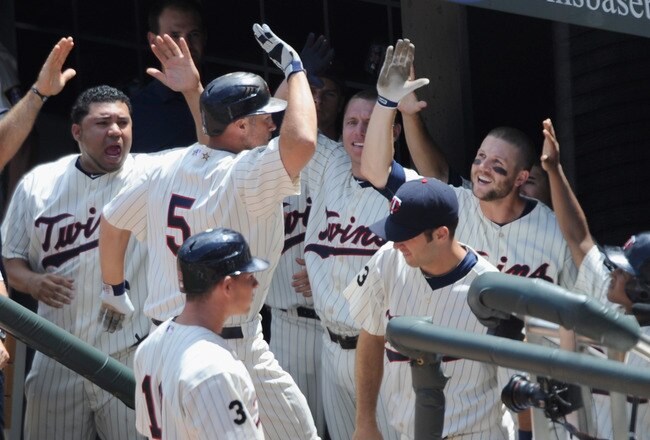 MINNEAPOLIS, MN - JULY 6: Michael Cuddyer #5 of the Minnesota Twins is welcomed back to the dugout after hitting a game tying solo home run against the Tampa Bay Rays in the seventh inning on July 6, 2011 at Target Field in Minneapolis, Minnesota. The Rays defeated the Twins 12-5. (Photo by Hannah Foslien/Getty Images)