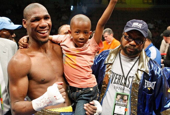 LAS VEGAS - APRIL 11:  Paul Williams holds his son Paul Williams Jr. as he and his trainer George Peterson celebrate defeating Winky Wright in a unanimous decision in their middleweight bout at the Mandalay Bay Events Center April 11, 2009 in Las Vegas, Nevada.  (Photo by Ethan Miller/Getty Images)