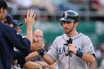 OAKLAND, CA - JULY 05:  Dustin Ackley #13 of the Seattle Mariners is congratulated by teammates after he scored in the second inning against the Oakland Athletics at Oakland-Alameda County Coliseum on July 5, 2011 in Oakland, California.  (Photo by Ezra Shaw/Getty Images)