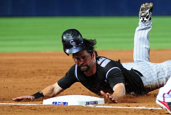 ATLANTA - JULY 6: Todd Helton #17 of the Colorado Rockies dives in to 3rd base on a double steal attempt against the Atlanta Braves at Turner Field on July 6, 2011 in Atlanta, Georgia. (Photo by Scott Cunningham/Getty Images)