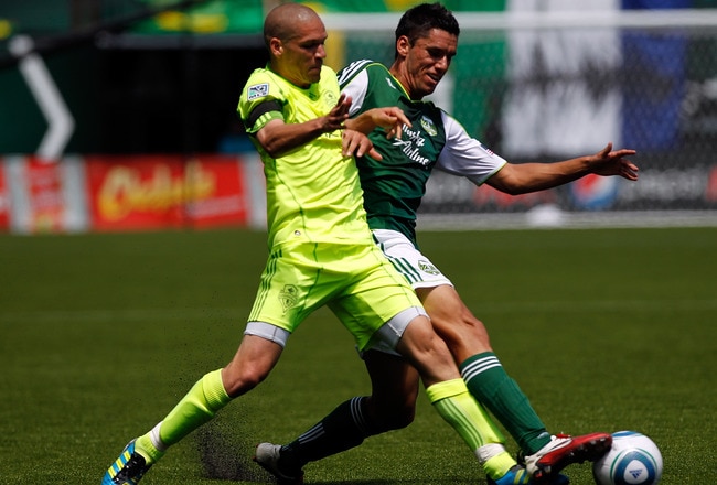 PORTLAND, OR - JULY 10: Osvaldo Alonso #6 of the Seattle Sounders battles Steve Purdy #25 of the Portland Timbers on July 10, 2011 at Jeld-Wen Field in Portland, Oregon. (Photo by Jonathan Ferrey/Getty Images)