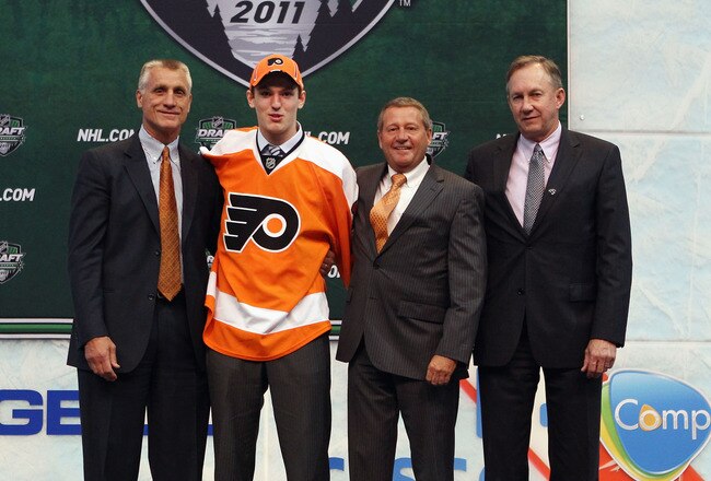 ST PAUL, MN - JUNE 24:  Eighth overall pick 	Sean Couturier by the Philadelphia Flyers stands with General Manager Paul Holmgren of the Philadelphia Flyers and members of the Philadelphia Flyers organization onstage during day one of the 2011 NHL Entry Draft at Xcel Energy Center on June 24, 2011 in St Paul, Minnesota.  (Photo by Bruce Bennett/Getty Images)
