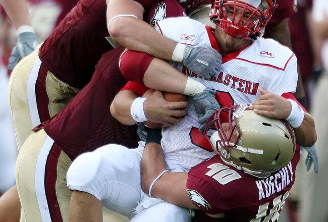 CHESTNUT HILL, MA - SEPTEMBER 05:  Matt Carroll #3 of the Northeastern Huskies is tackled by Dillon Quinn #92,Kaleb Ramsey #96 and Luke Kuechly #40  of the Boston College Eagles on September 5, 2009 at Alumni Stadium in Chestnut Hill, Massachusetts.  (Photo by Elsa/Getty Images)