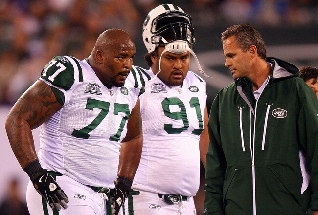 EAST RUTHERFORD, NJ - SEPTEMBER 13:  Kris Jenkins #77 of the New York Jets  comes out of the game after getting injured while playing against the Baltimore Ravens as Sione Pouha #91 looks on during their home opener at the New Meadowlands Stadium on September 13, 2010 in East Rutherford, New Jersey.  (Photo by Andrew Burton/Getty Images)