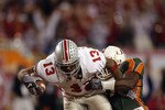 TEMPE, AZ - JANUARY 3:  Running back Maurice Clarett #13 of the Ohio State Buckeyes lunges for the goaline to score the team's second touchdown against the University of Miami Hurricanes during the Tostitos Fiesta Bowl at Sun Devil Stadium on January 3, 2003 in Tempe, Arizona.  Ohio State won the game 31-24 in double-overtime, winning the NCAA National Championship.  (Photo by Brian Bahr/Getty Images)