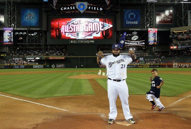 PHOENIX, AZ - JULY 12:  National League All-Star Prince Fielder #28 of the Milwaukee Brewers poses with the Ted Williams Most Valuable Player Award after the National League defeated the American League 5-1 in the 82nd MLB All-Star Game as his son Haven runs in the background at Chase Field on July 12, 2011 in Phoenix, Arizona.  (Photo by Jeff Gross/Getty Images)