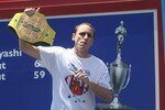 NEW YORK - JULY 4: Joey Chestnut of San Jose, California walks on stage holding his old champion belt as the Nathan's Famous Fourth of July hot dog eating contest begins on July 4, 2009 in Coney Island in the Brooklyn borough of New York City. Chestnut defeated Takeru Kobayashi of Nagano, Japan with eating 68 to his 64.5 hotdogs. Kobayashi won six previous competitions before tying last year with Chestnut. (Photo by Yana Paskova/Getty Images)