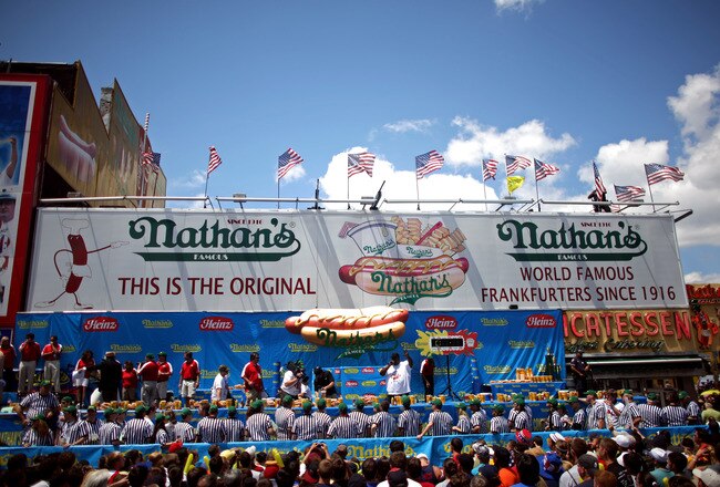 NEW YORK - JULY 4:  Referees gather under the stage before the Nathan's Famous Fourth of July hot dog eating contest begins on July 4, 2009 in Coney Island in the Brooklyn borough of New York City. Joey Chestnut of San Jose, California defeated Takeru Kobayashi of Nagano, Japan with eating 68 to his 64.5 hotdogs. Kobayashi won six previous competitions before tying last year with Chestnut. (Photo by Yana Paskova/Getty Images)