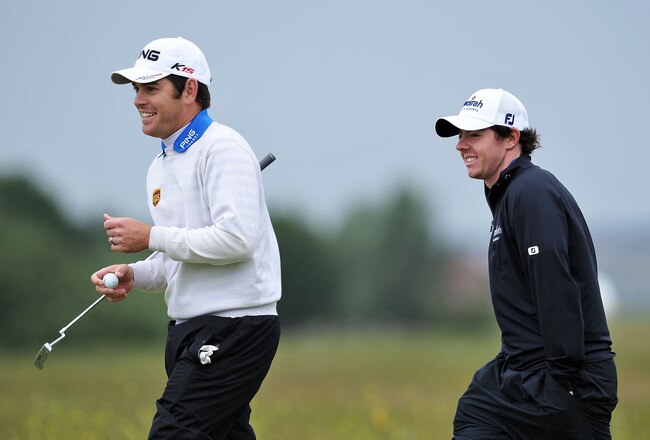 SANDWICH, ENGLAND - JULY 13:  (L to R) Louis Oosthuizen of South Africa and Rory McIlroy of Northern Ireland walk across a green the final practice round during The Open Championship at Royal St. George's on July 13, 2011 in Sandwich, England. The 140th Open begins on July 14, 2011.  (Photo by Stuart Franklin/Getty Images)