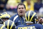 ANN ARBOR, MI - APRIL 16: Head football coach Brady Hoke talks with his team during the annual Spring Game at Michigan Stadium on April 16, 2011 in Ann Arbor, Michigan. (Photo by Leon Halip/Getty Images)