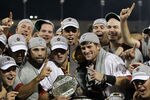 OMAHA, NE - JUNE 28:  (L-R) Brady Thomas #36 and Scott Wingo #8 of the South Carolina Gamecocks celebrate with the team while holding the trophy after winning the men's 2011 NCAA College Baseball World Series at TD Ameritrade Park Omaha on June 28, 2011 in Omaha, Nebraska.  The Gamecocks defeated the Florida Gators 5-2 and won the series 2-0.  (Photo by Ronald Martinez/Getty Images)