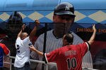 PHOENIX, AZ - JULY 12:  Fans yell as a light rail bus goes in front of fans during the MLB All-Star Game Red Carpet Show and Parade at Chase Field on July 12, 2011 in Phoenix, Arizona. A picture of Derek Jeter #2 of the New York Yankees, who is not attending the game, is displayed on the side of the bus. (Photo by Norm Hall/Getty Images)