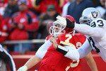 KANSAS CITY, MO - JANUARY 02:  Quarterback Matt Cassel #7 of the Kansas City Chiefs is hit as he throws by defensive tackle Tommy Kelly #93 of the Oakland Raiders in a game at Arrowhead Stadium on January 2, 2011 in Kansas City, Missouri.  (Photo by Tim Umphrey/Getty Images)