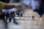 TEL AVIV, ISRAEL - OCTOBER 21: (ISRAEL OUT) A Israeli chess player makes a move against Grandmaster Alik Gershon, during an attempt to break the Guinness world record of simultaneous chess play on October 21, 2010 in Tel Aviv, Israel. Hundreds of chess players in Israel are attempting to break the Guinness world record of simultaneous chess play. Iran currently holds the world record of 500 games played simultaneously.  (Photo by Uriel Sinai/Getty Images)
