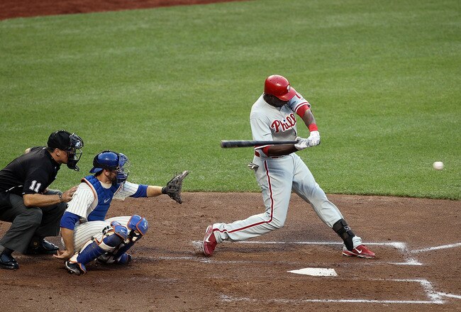 NEW YORK, NY - JULY 15:  John Mayberry #15 of the Philadelphia Phillies connects on a second-inning two-run single against the New York Mets at Citi Field on July 15, 2011 in the Flushing neighborhood of the Queens borough of New York City.  (Photo by Jim McIsaac/Getty Images)